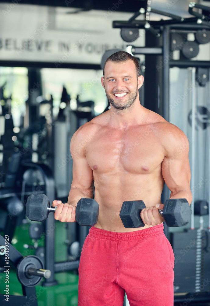 Man at the gym. Man makes exercises with barbell Man at the gym. Man makes exercises with barbell
