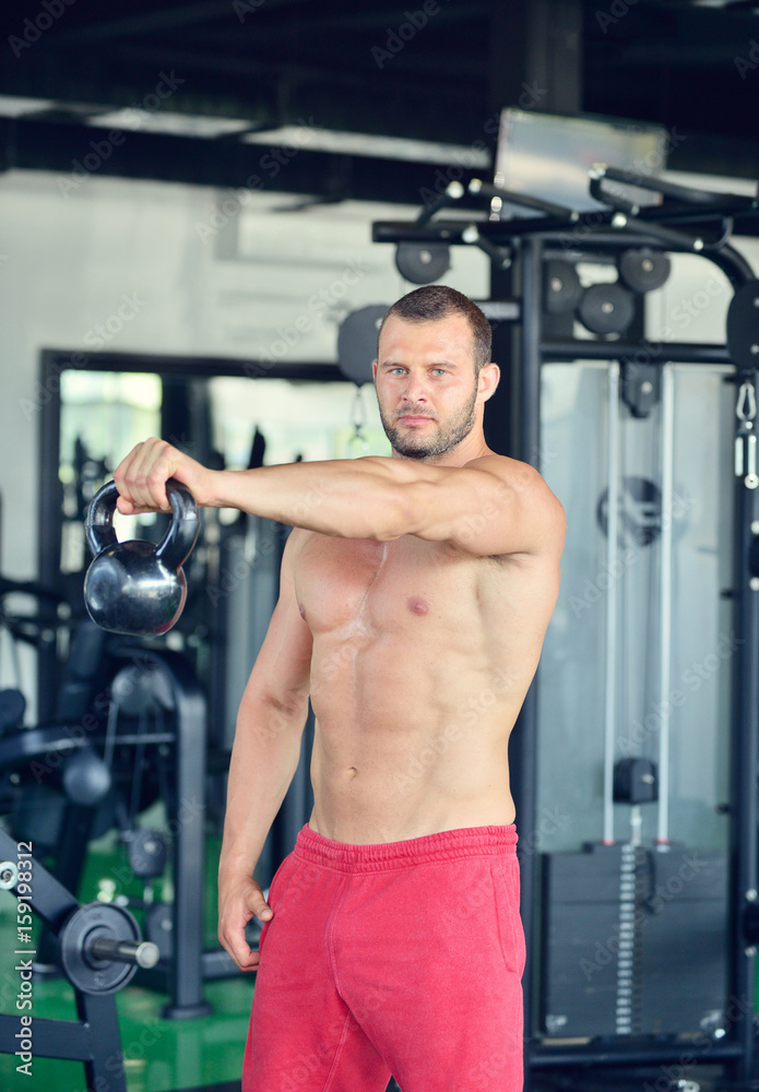 Man at the gym. Man makes exercises with barbell Man at the gym. Man makes exercises with barbell