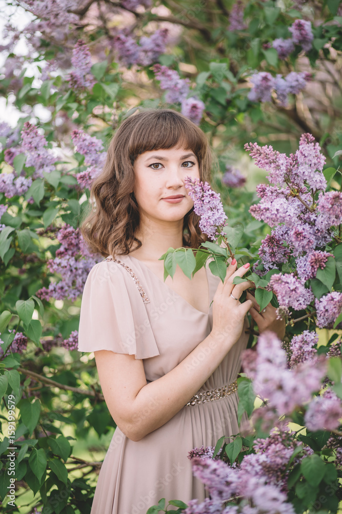 portrait of a summer in the woods, in a Park, very beautiful, young, lovely girl in black dress among the trees near the lilac with purple flowers, close-up portrait of a summer in the woods, in a Park, very beautiful, young, lovely girl in black dress among the trees near the lilac with purple flowers, close-up