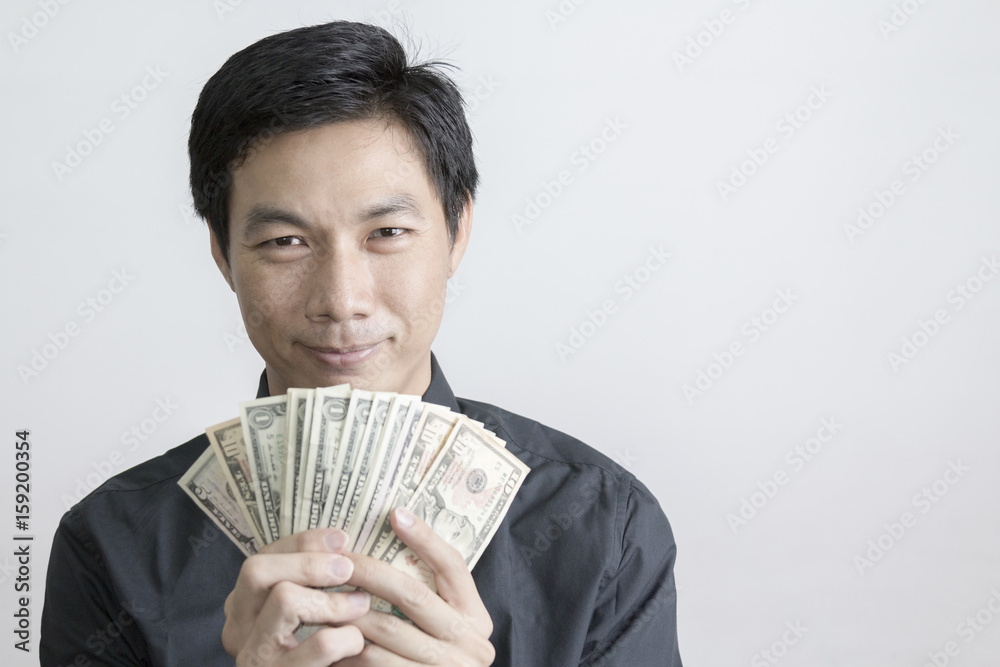 Portrait of Asian businessman holding dollar banknote Portrait of Asian businessman holding dollar banknote
