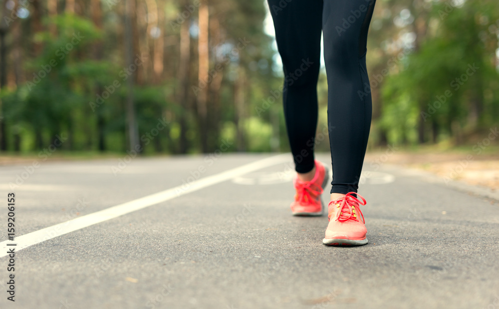 Crop image. Legs of young fitness woman running outdoor. Crop image. Legs of young fitness woman running outdoor.