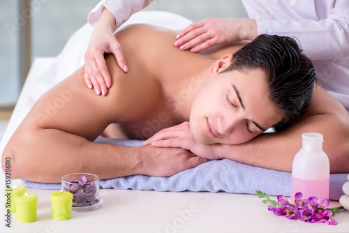 Handsome man in spa massage concept