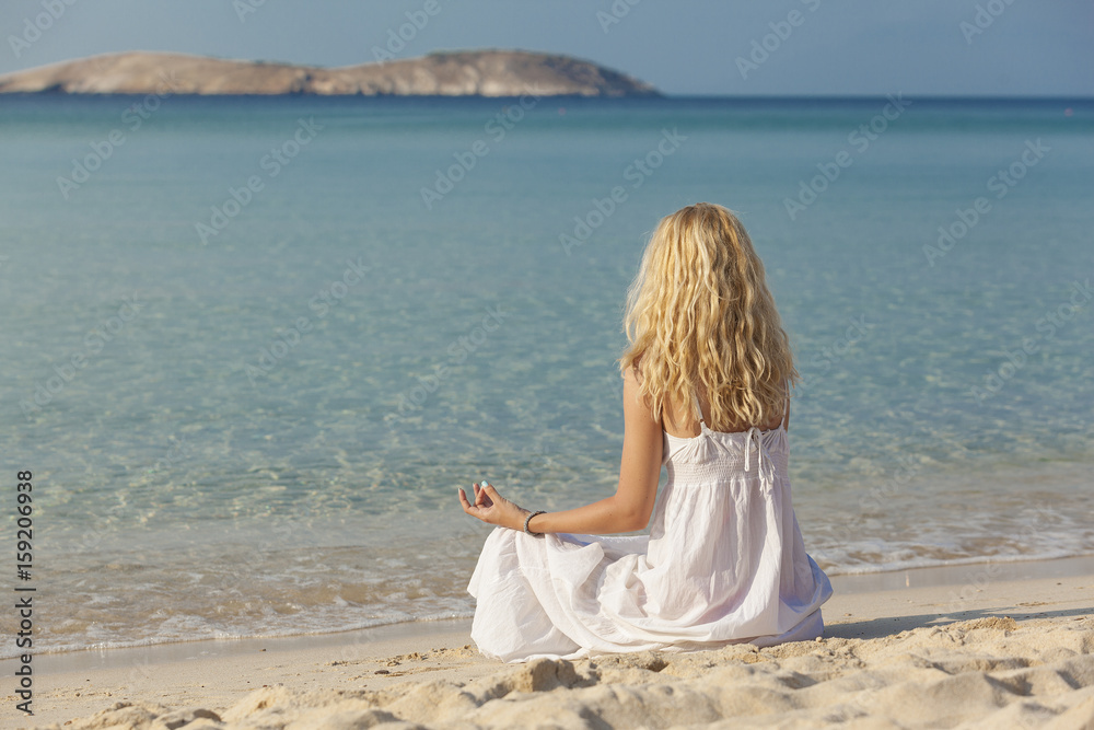 young woman practicing yoga on the beach young woman practicing yoga on the beach