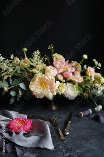 Wedding decor, Pink peony on silk napkins and flower arrangement on a dark background, Wedding bouquet, Decorator, Copy Space, Selective focus