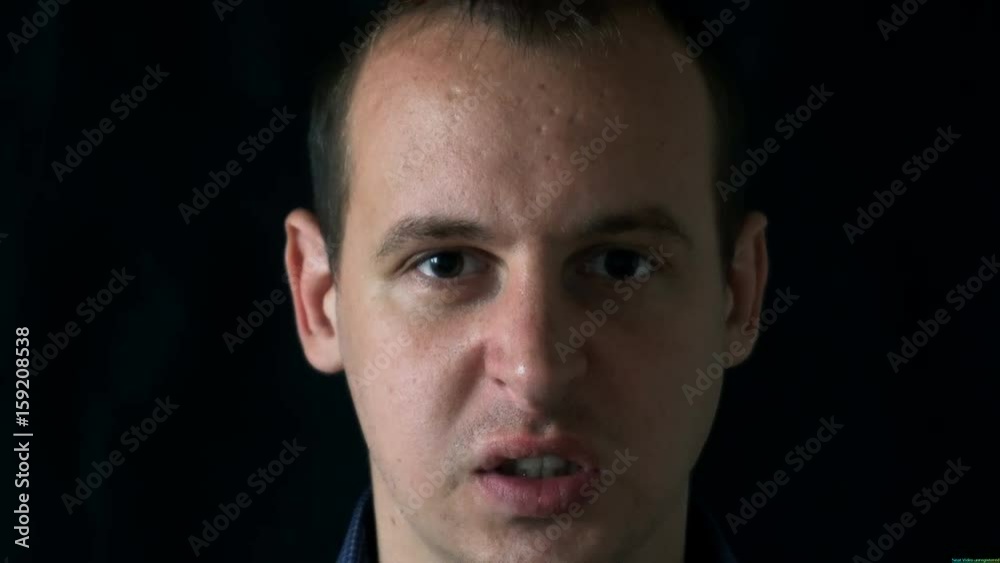 angry young man on black background. angry young man on black background.
