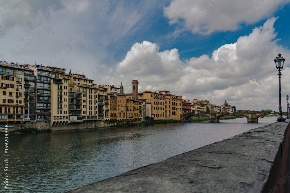 Horizontal composition of the River Arno in Florence  with dramatic clouds.