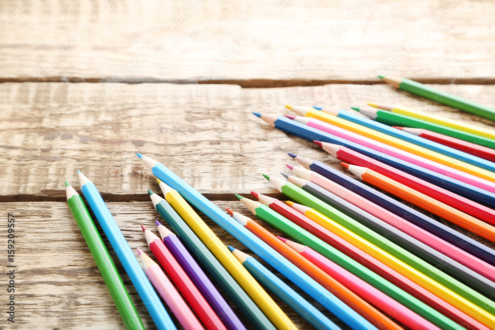Drawing colourful pencils on brown wooden table Drawing colourful pencils on brown wooden table
