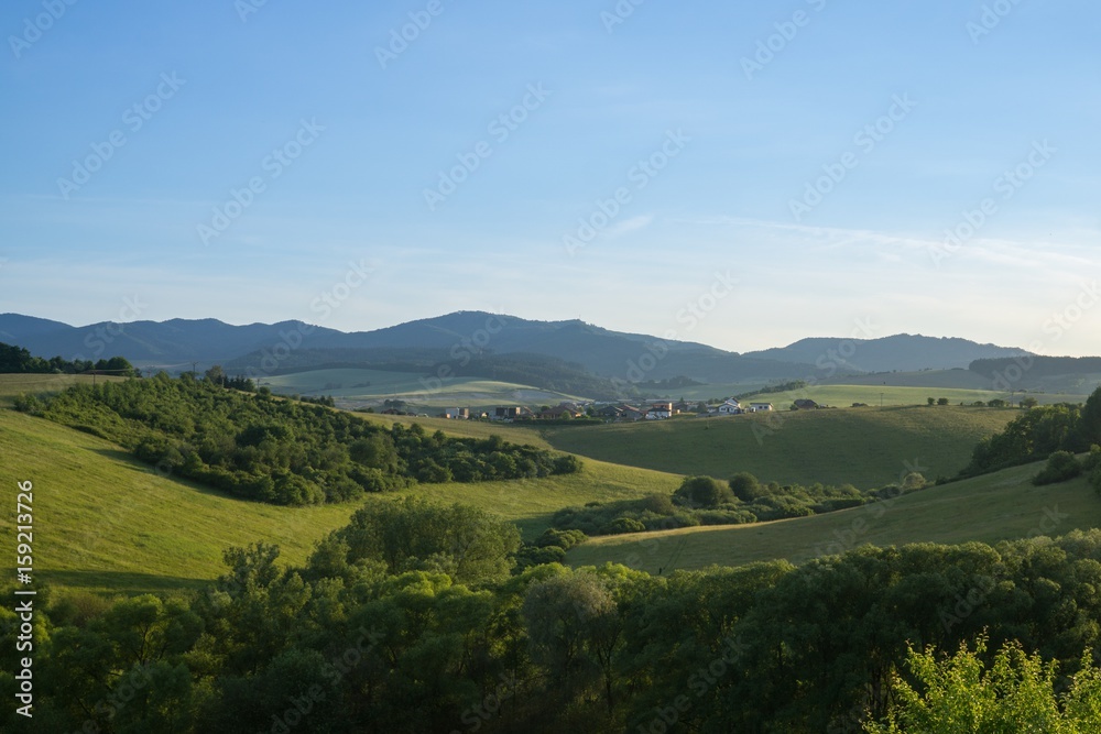 Fototapeta premium Sunrise and sunset over the hills and town. Slovakia