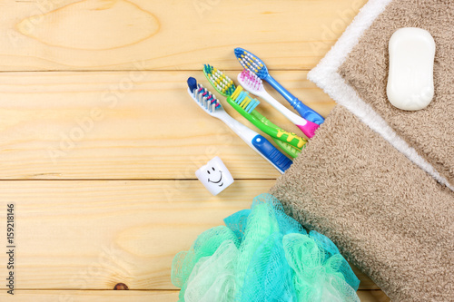 toothbrush tooth-brush with soap, bath towel and wisp of bast on wood background photo