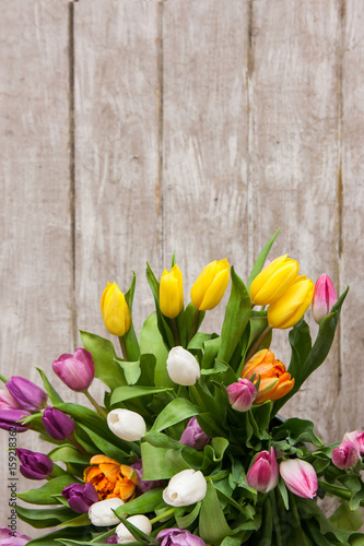 Frame of colorful flower tulips. Floral background. Big spring bouquet on wooden backdrop with copyspace. Wedding, gift, birthday, 8 march, easter, mother's day greeting card concept