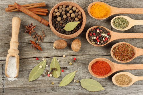 spices in spoon on old wood background