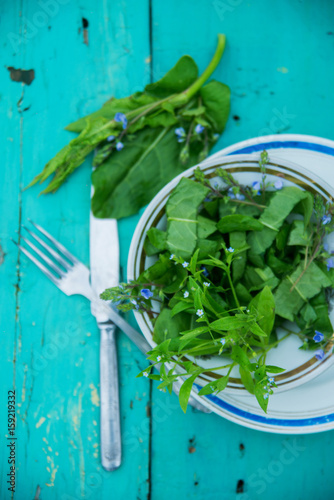 Wicker basket with fresh herbs photo