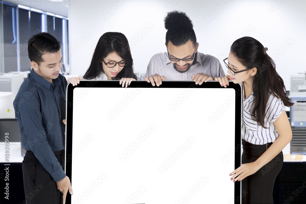 Businesspeople holding blank signboard Businesspeople holding blank signboard
