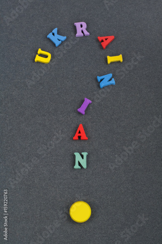 UKRAINIAN word on black board background composed from colorful abc alphabet block wooden letters, copy space for ad text. Learning english concept.