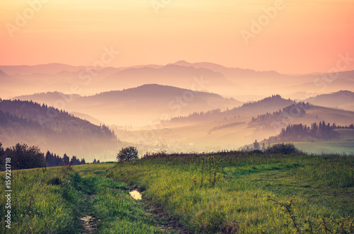 Moments before sunrise in misty Carpathian mountains, spring, Poland