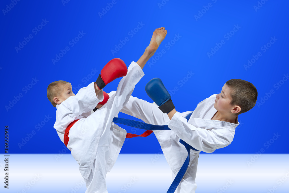 Sportsmen are beating kicks on a light blue background Sportsmen are beating kicks on a light blue background