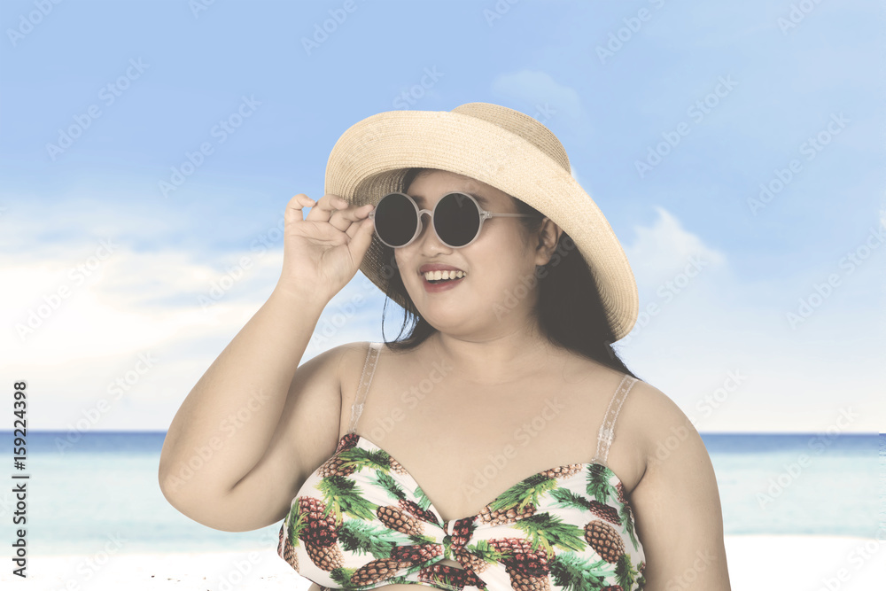 Fat woman with bikini at shore Fat woman with bikini at shore
