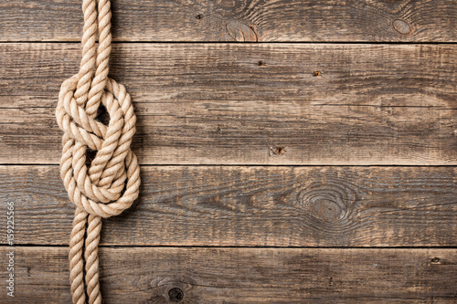 Rope knot on wooden board photo