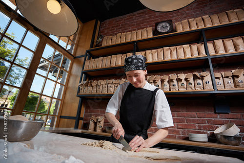 Woman cutting knead in restaurant