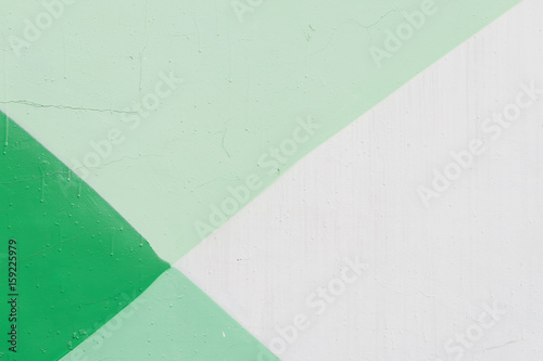 Abstract detail of wall with fragment of graffiti, old chipped paint, scratch, grunge texture. Aerosol design. Different shades of green color. For modern background, banner design photo