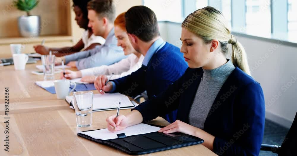 Executive taking down notes Executive taking down notes