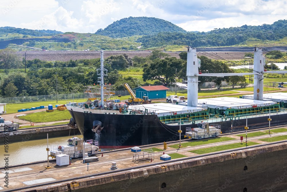 Fototapeta premium Ship crossing Panama Canal at Miraflores Locks - Panama City, Panama