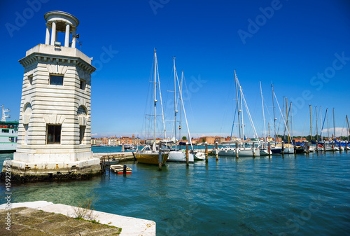 A view on San Giorgio Maggiore Island's lighthouse with yachting harbour in the background, Venice, Italy