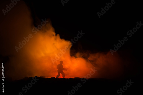 War Concept. Military silhouettes fighting scene on war fog sky background  World War Soldiers Silhouettes Below Cloudy Skyline At night. Attack scene. Armored vehicles. Tanks battle
