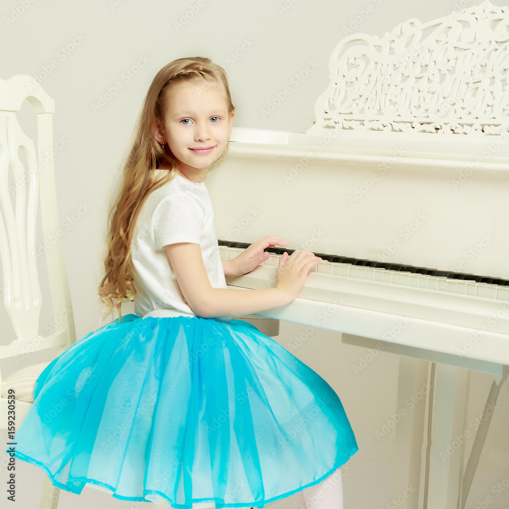 Caucasian little girl with long blond hair, in a beautiful pink Caucasian little girl with long blond hair, in a beautiful pink