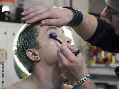Make up artist makes make-up at the eyelashes close-up