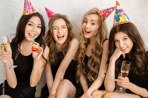 Young women together celebrating birthday isolated on white