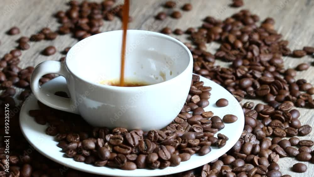 The coffee is filling the cup