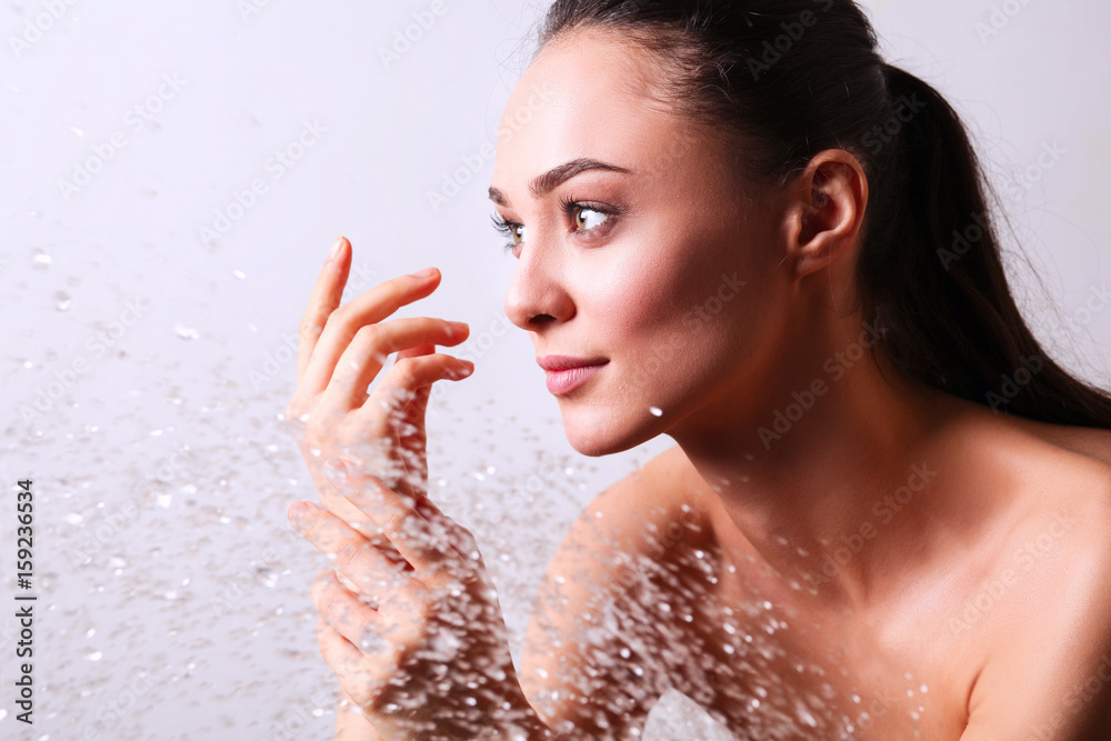Young beautyful woman under shower in bathroom Young beautyful woman under shower in bathroom