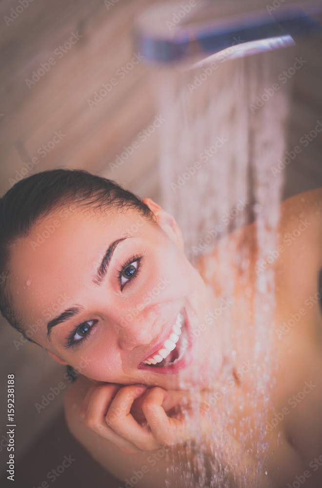 Naklejka premium Young beautyful woman under shower in bathroom