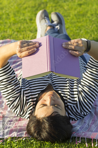 woman with books on grass
