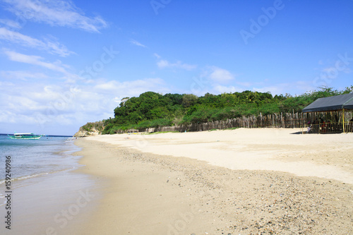 Beautiful view of an empty beach with greens in the background