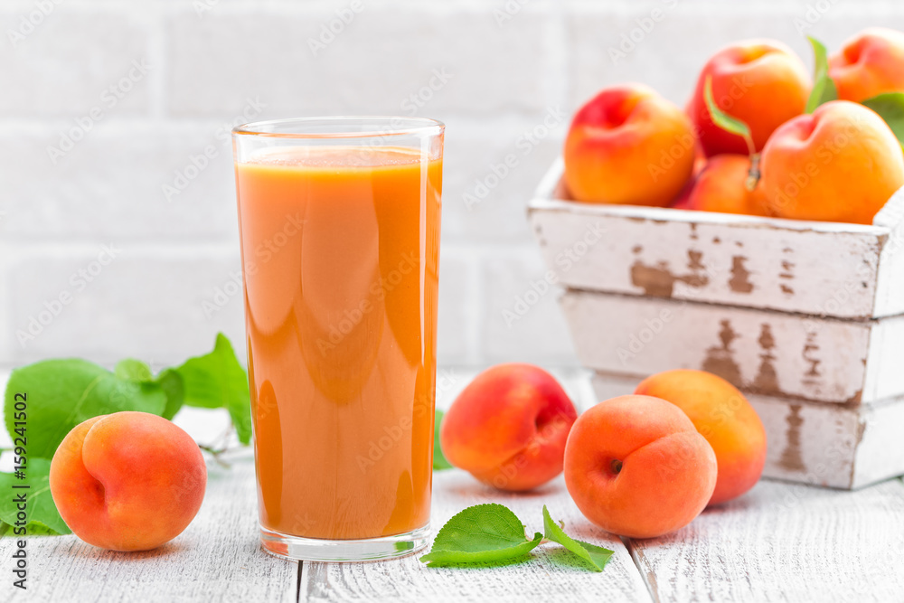 Apricot juice and fresh fruits with leaves Apricot juice and fresh fruits with leaves
