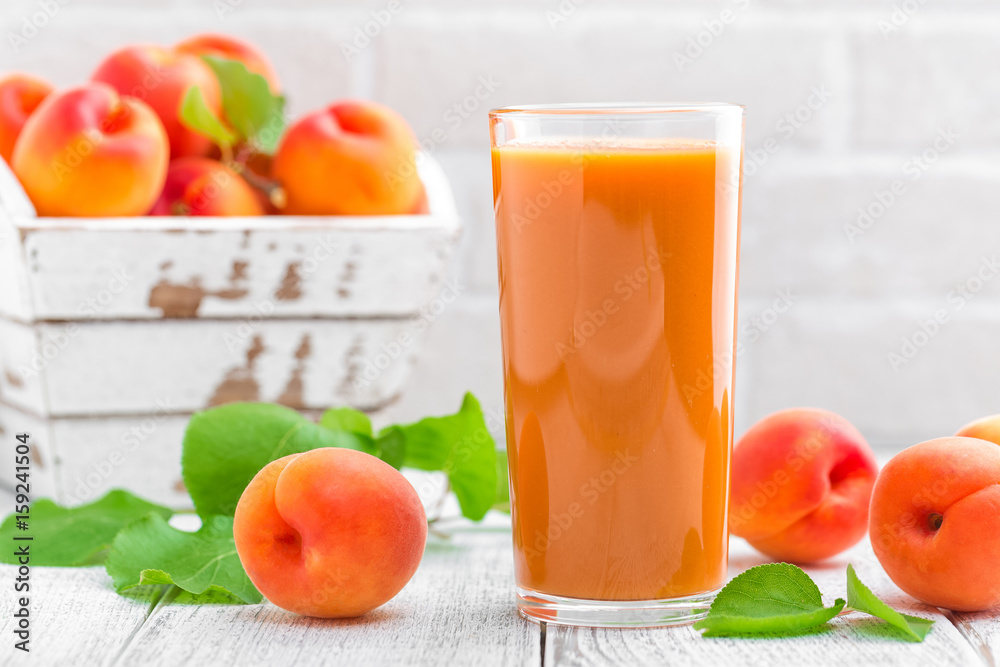 Apricot juice and fresh fruits with leaves Apricot juice and fresh fruits with leaves