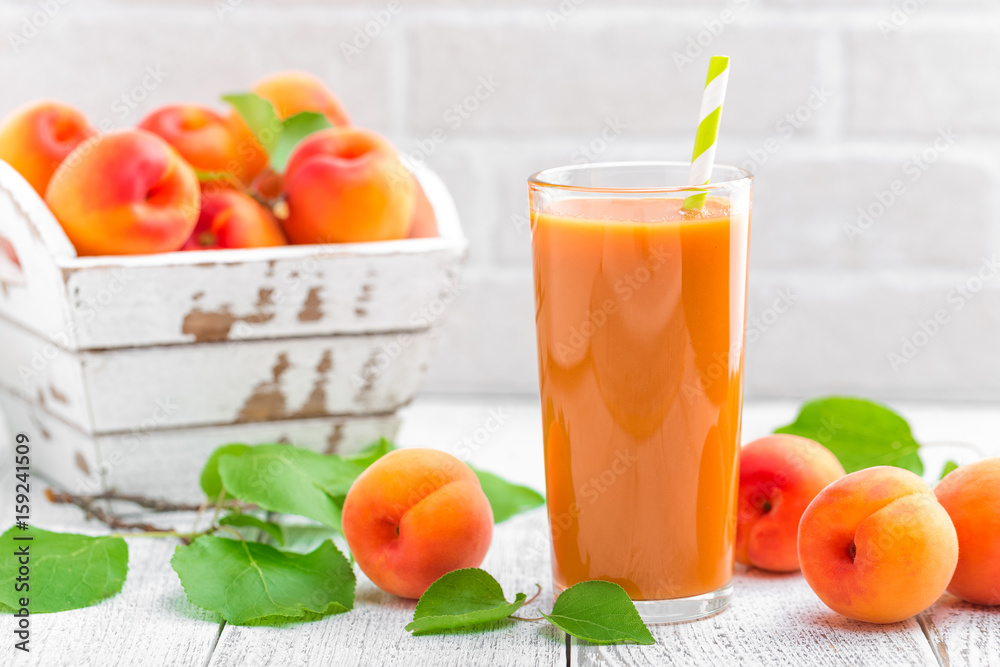 Apricot juice and fresh fruits with leaves Apricot juice and fresh fruits with leaves
