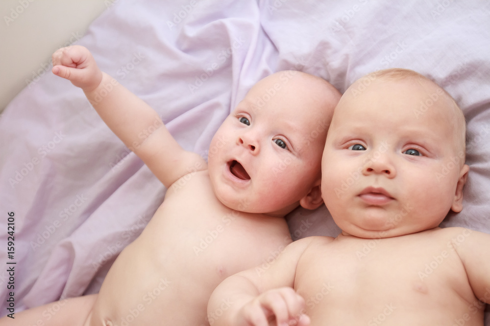 indoor portrait of two young baby twins at home indoor portrait of two young baby twins at home