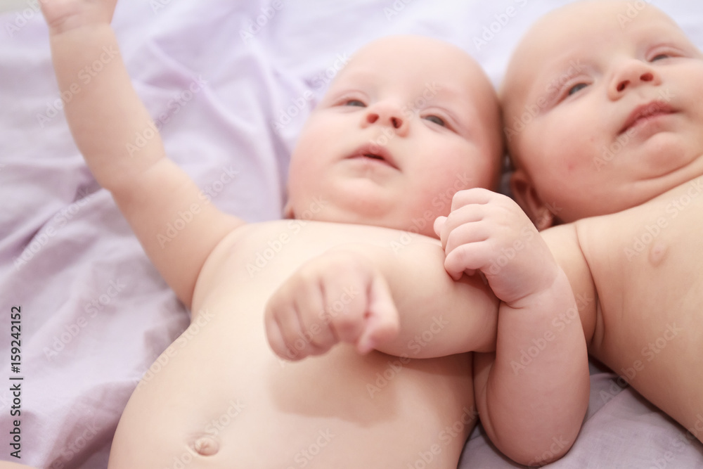 indoor portrait of two young baby twins at home indoor portrait of two young baby twins at home