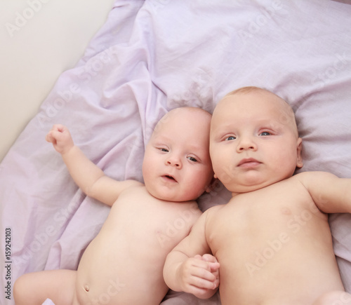 indoor portrait of two young baby twins at home