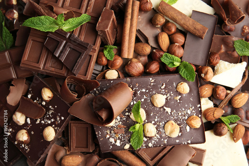 Heap of broken chocolate pieces with mint, close up