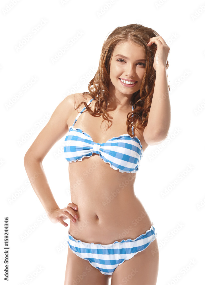 Beautiful young woman in swimsuit on white background