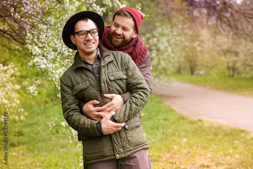 Happy gay couple hugging in...