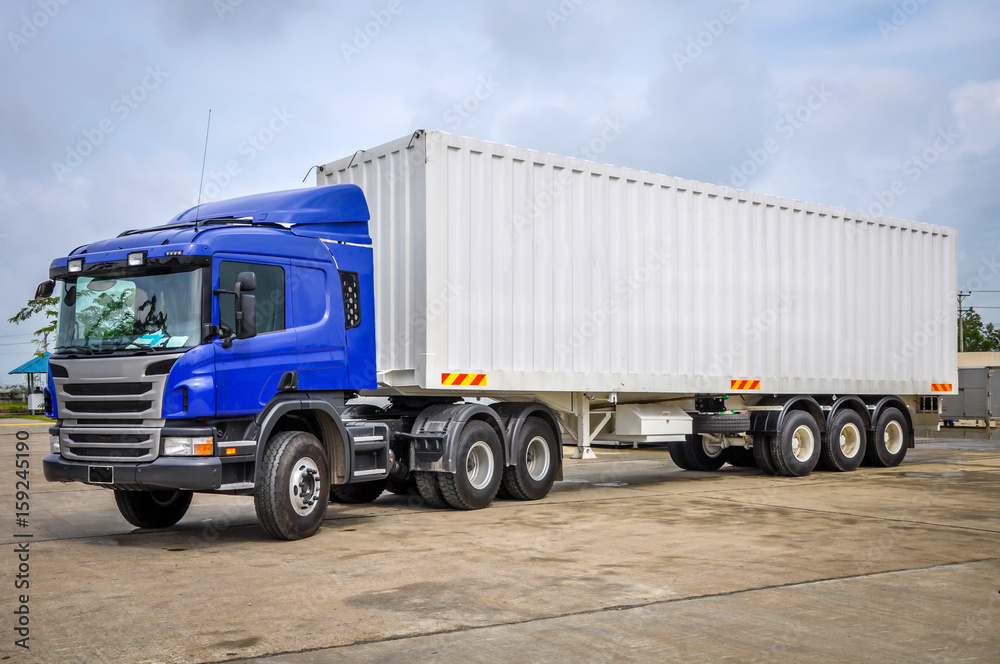 photo of big tractor, with container trailer, to deliver goods and products