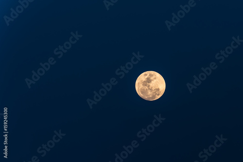 Big moon on blue sky background