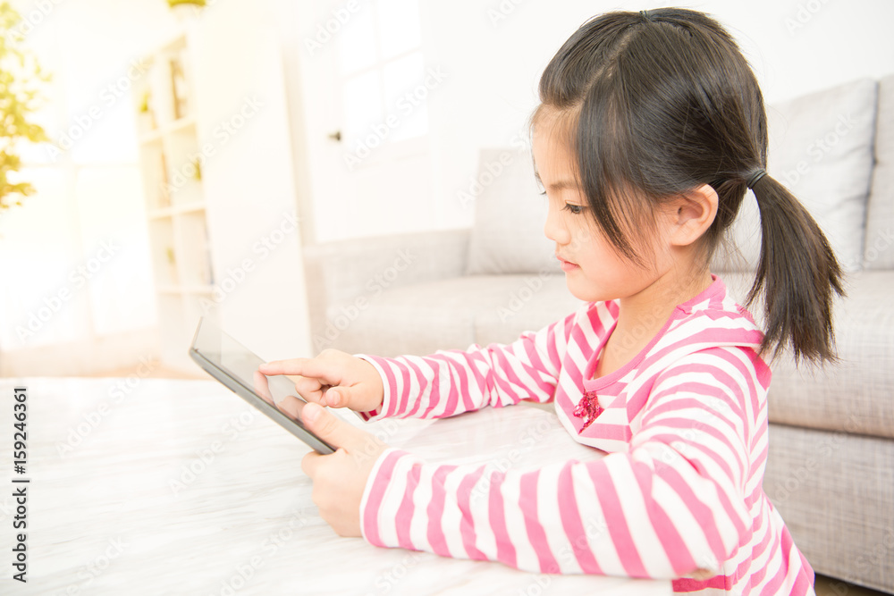 school girl while using digital tablet school girl while using digital tablet