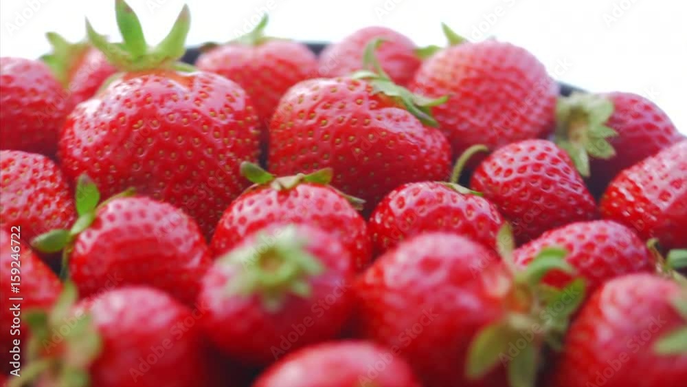 Fresh, ripe, juicy strawberries rotate. Red strawberries clockwise rotation. Appetizing berries with droplets rotate on a tray Fresh, ripe, juicy strawberries rotate. Red strawberries clockwise rotation. Appetizing berries with droplets rotate on a tray
