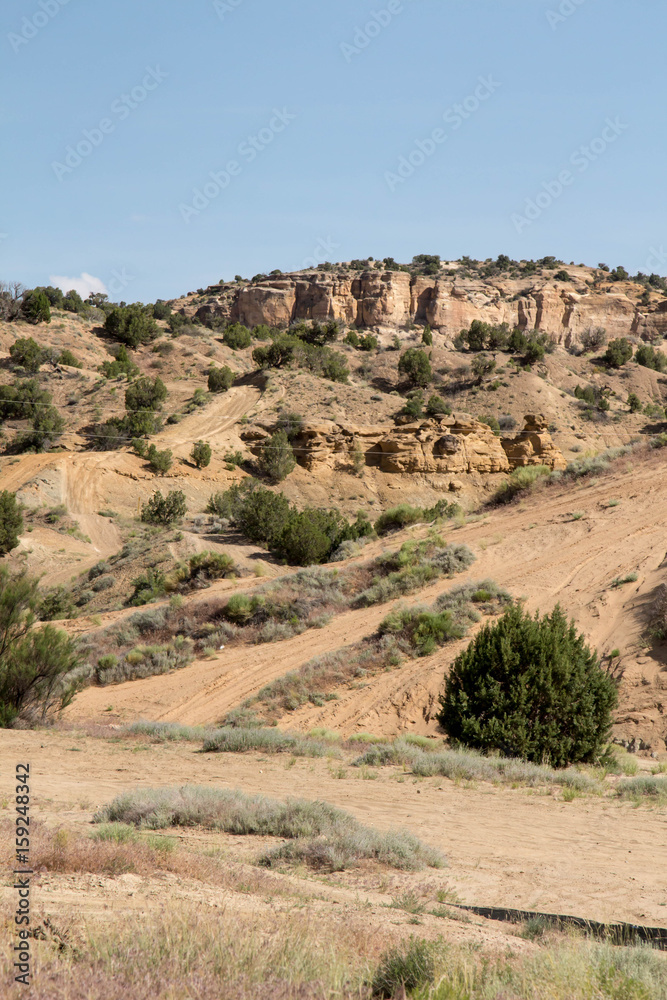 Sandstone rock formations and sand trails at The Dunes in Farmington, NM
